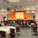 conference-room-stage-empty-tables-chairs-set-up-facing-podium-screen-102855326